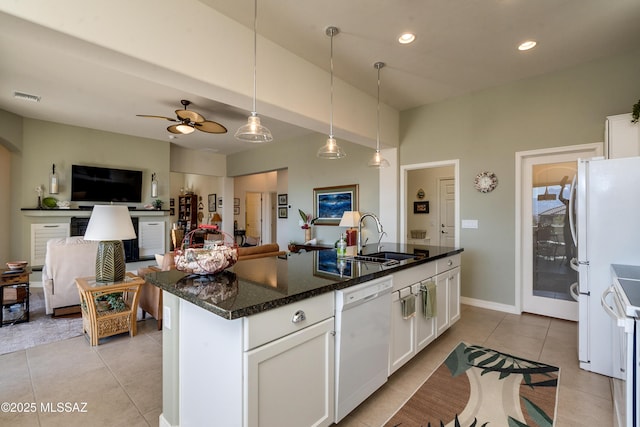 kitchen with light tile patterned flooring, white appliances, a sink, visible vents, and open floor plan