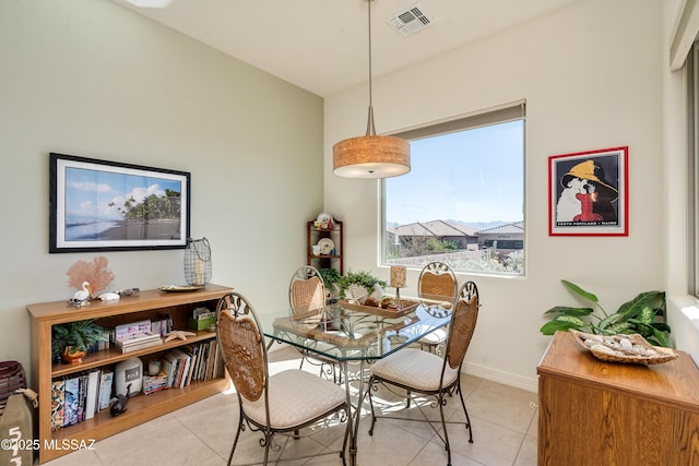 dining space featuring light tile patterned flooring, visible vents, and baseboards