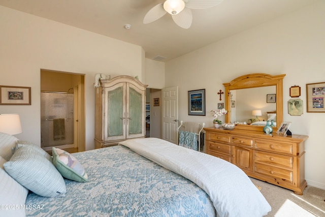 bedroom with light carpet, ensuite bath, and a ceiling fan