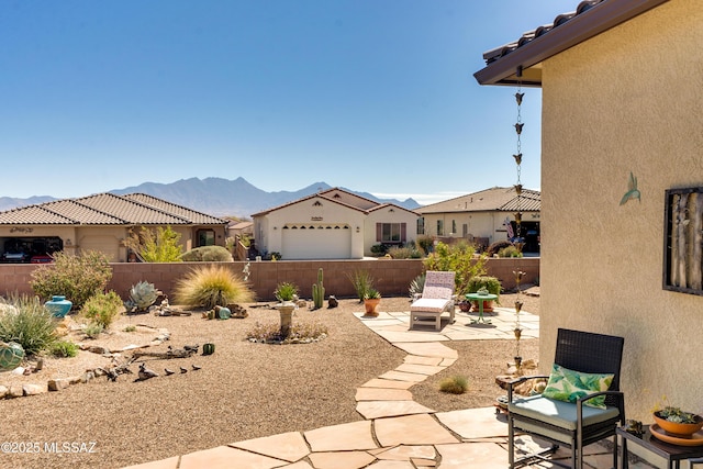 exterior space with a fenced backyard and a mountain view