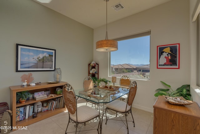 dining room featuring light tile patterned flooring, visible vents, and baseboards