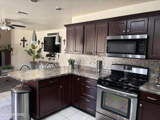 kitchen featuring stainless steel appliances, tasteful backsplash, a peninsula, and ceiling fan