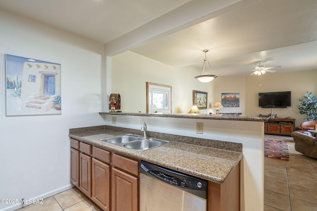 kitchen with light tile patterned floors, a peninsula, a sink, open floor plan, and dishwasher