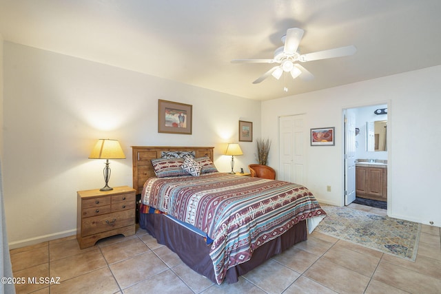 bedroom featuring a closet, light tile patterned flooring, and baseboards