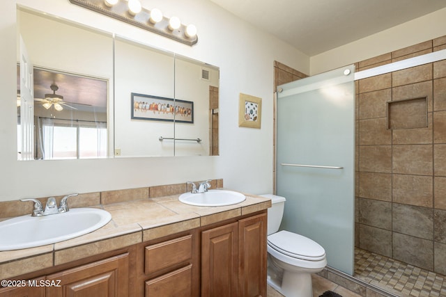 full bath with visible vents, a sink, toilet, and a shower stall