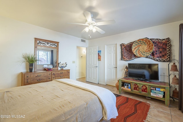 tiled bedroom with ceiling fan, visible vents, and baseboards