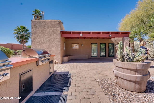 view of patio featuring exterior kitchen and area for grilling