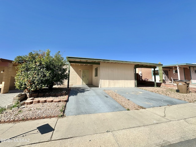 view of front of property featuring an attached carport and concrete driveway