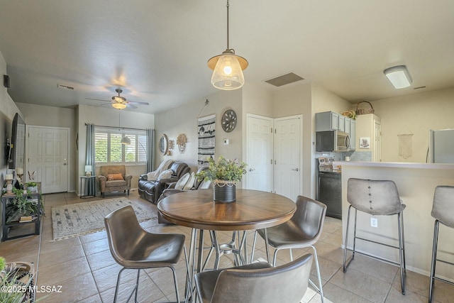 dining space featuring ceiling fan, light tile patterned floors, and visible vents