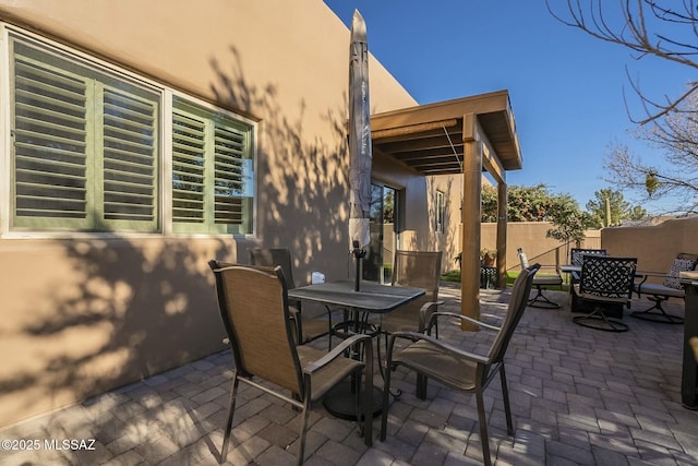 view of patio / terrace with outdoor dining space and fence