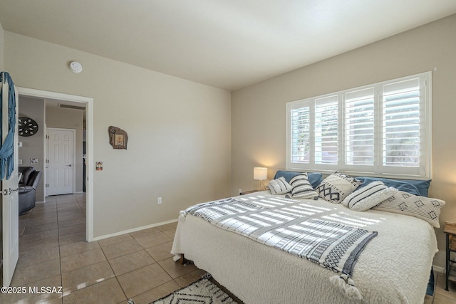 bedroom featuring baseboards and light tile patterned flooring