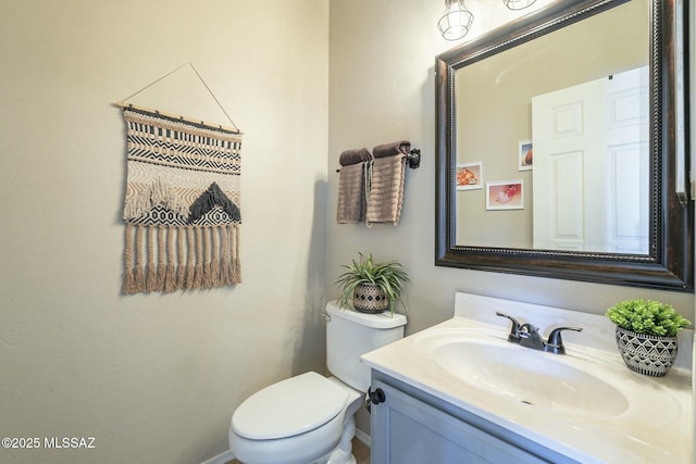 half bathroom with toilet and vanity