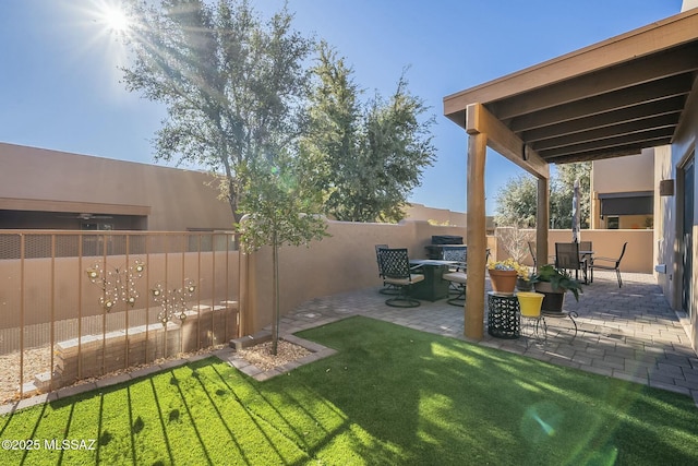 view of yard featuring outdoor dining area, a patio area, and fence