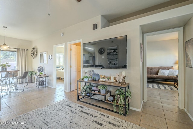 hallway featuring baseboards and light tile patterned floors