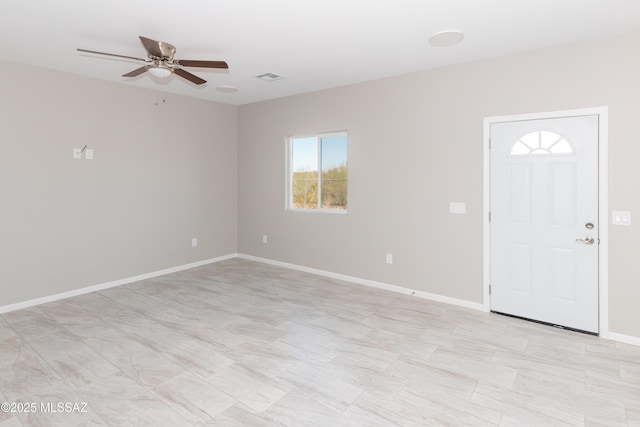 entrance foyer featuring visible vents, ceiling fan, and baseboards