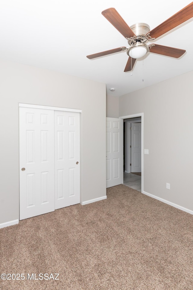 unfurnished bedroom featuring a closet, baseboards, and carpet