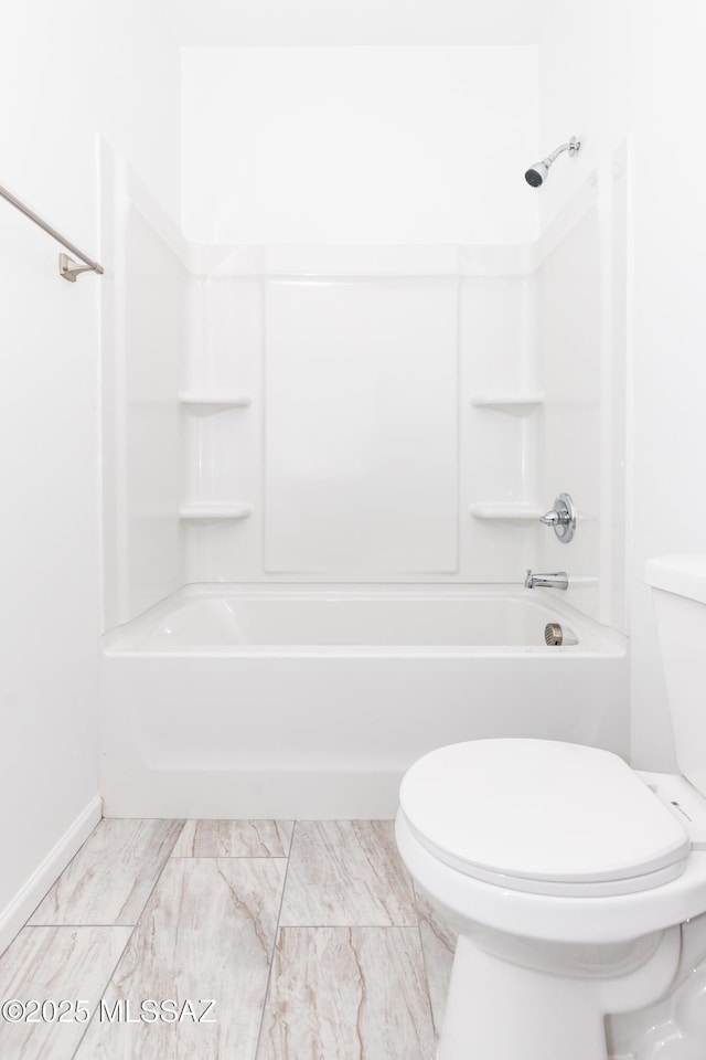 bathroom with toilet and  shower combination