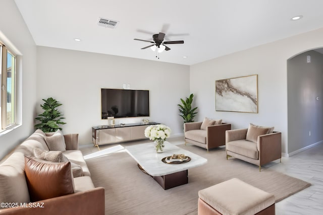 living room featuring recessed lighting, arched walkways, visible vents, and ceiling fan
