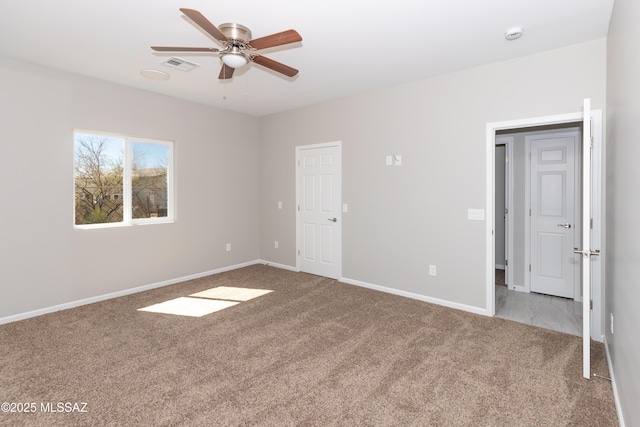 unfurnished bedroom with a ceiling fan, carpet flooring, baseboards, and visible vents