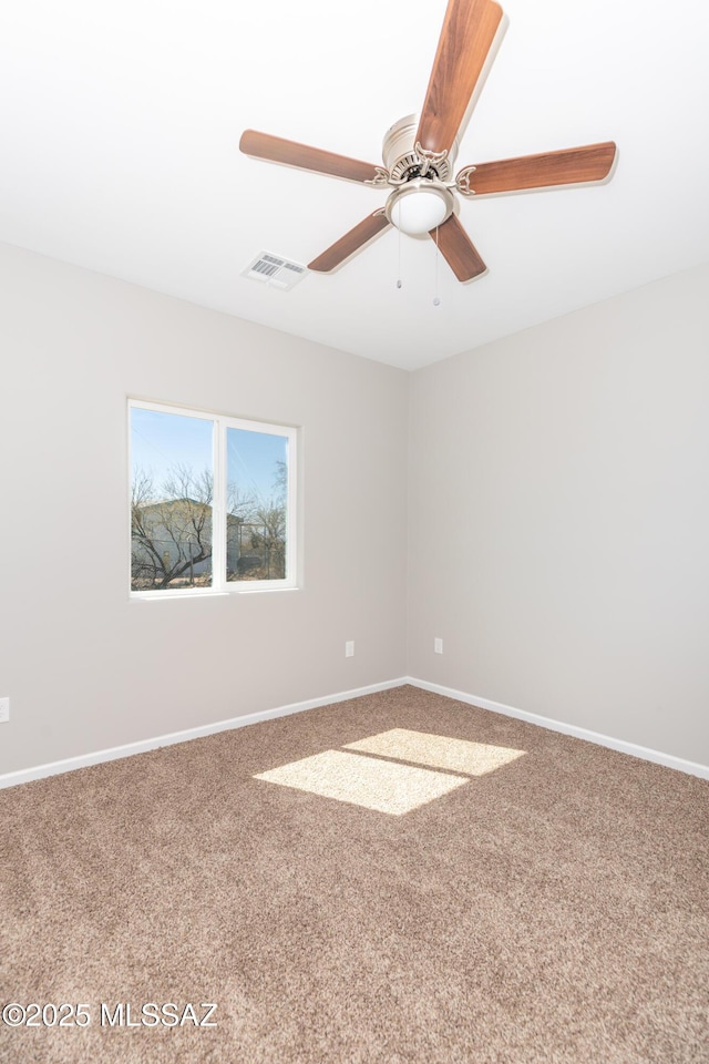 unfurnished room featuring carpet flooring, visible vents, baseboards, and ceiling fan