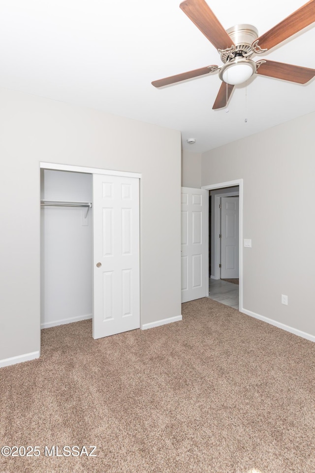 unfurnished bedroom with a closet, baseboards, and carpet floors
