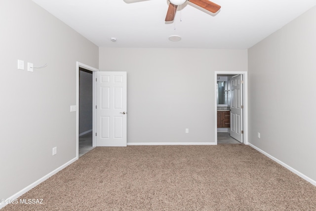unfurnished bedroom with ceiling fan, baseboards, connected bathroom, and carpet floors