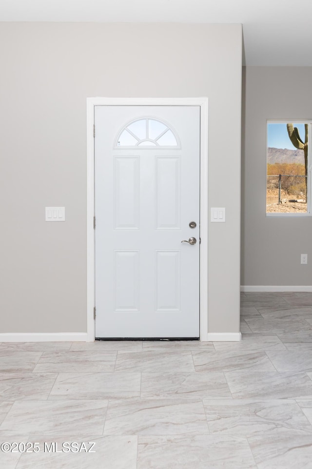 foyer entrance with baseboards