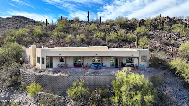 back of house featuring a patio and stucco siding