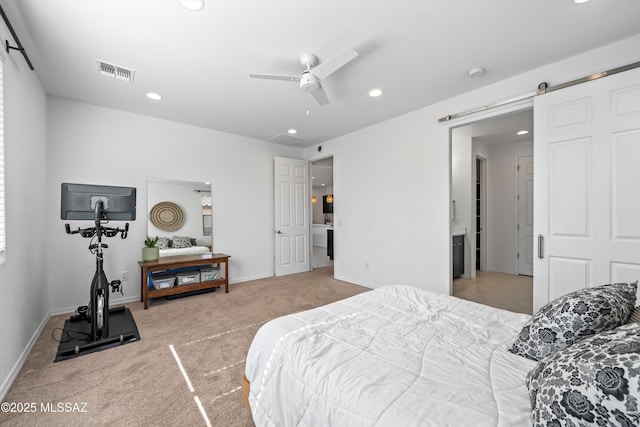 bedroom with a barn door, baseboards, visible vents, carpet, and recessed lighting
