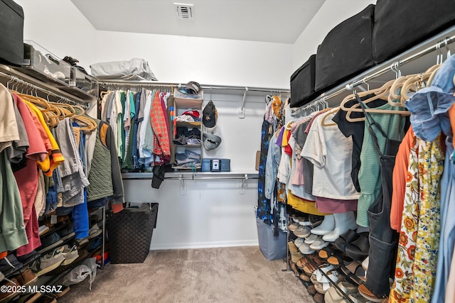 spacious closet featuring visible vents and carpet flooring