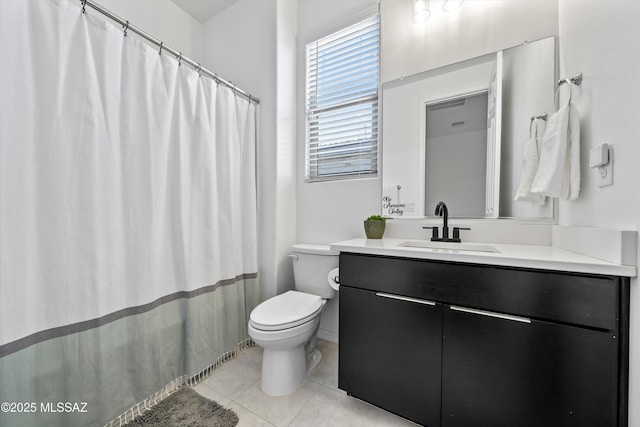 bathroom featuring toilet, vanity, and tile patterned floors