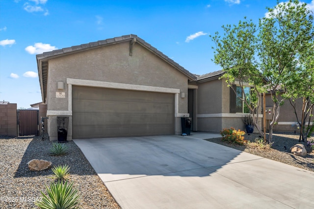 ranch-style house featuring a garage, concrete driveway, a gate, and stucco siding
