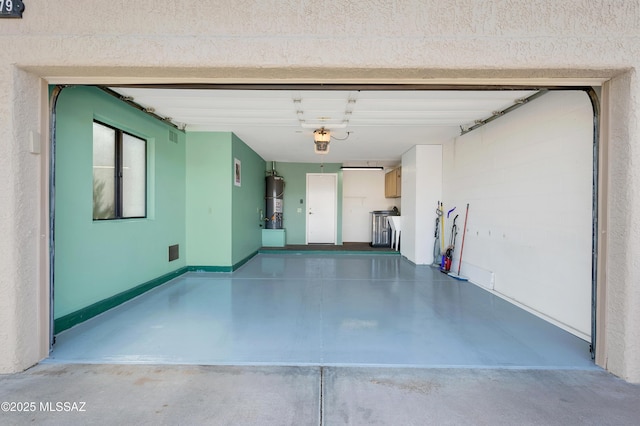 garage featuring secured water heater and a garage door opener