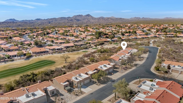 drone / aerial view featuring a residential view, a mountain view, and golf course view