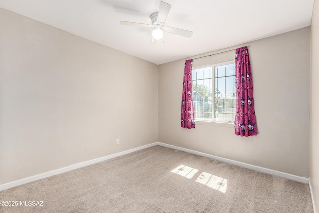 empty room featuring carpet, a ceiling fan, and baseboards