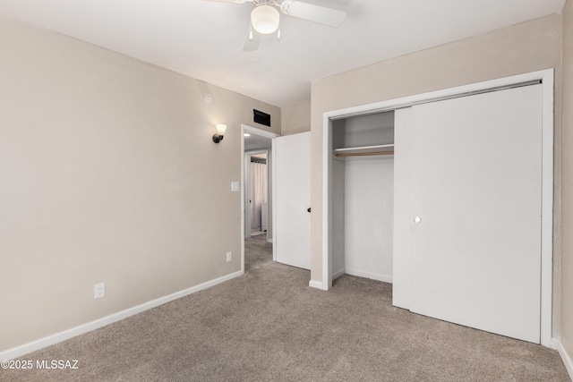 unfurnished bedroom featuring baseboards, visible vents, a ceiling fan, carpet floors, and a closet