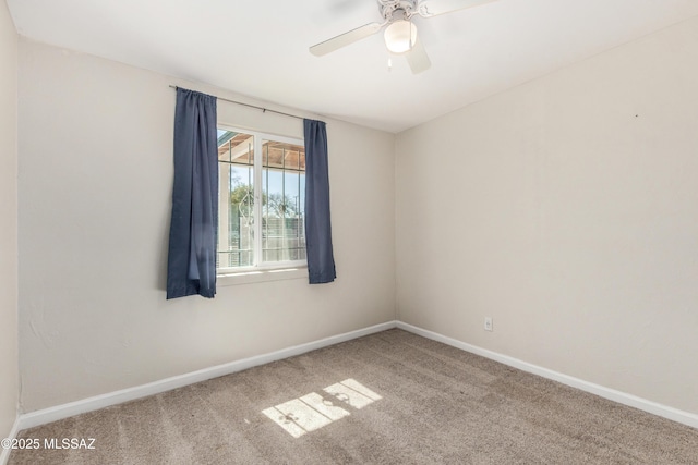 spare room with ceiling fan, baseboards, and carpet flooring