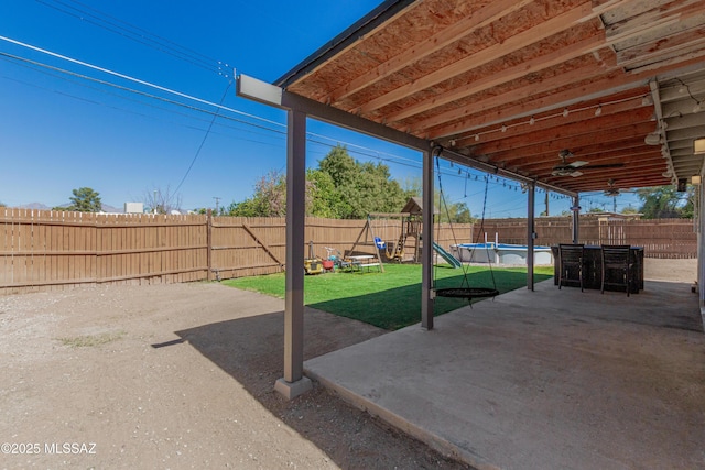 view of patio / terrace with a fenced backyard, ceiling fan, and a fenced in pool