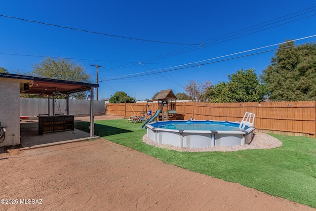 view of pool featuring a patio area, a fenced backyard, a lawn, and a fenced in pool