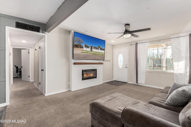 carpeted living area with beamed ceiling, a fireplace, visible vents, and baseboards