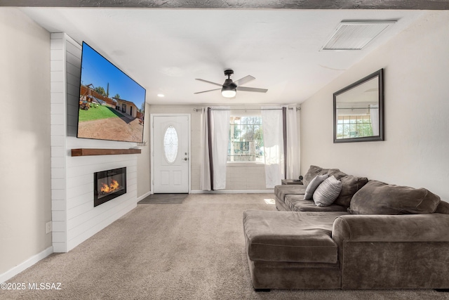 carpeted living area with baseboards, a fireplace, visible vents, and a ceiling fan