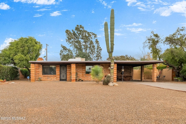 view of front of home with an attached carport and concrete driveway