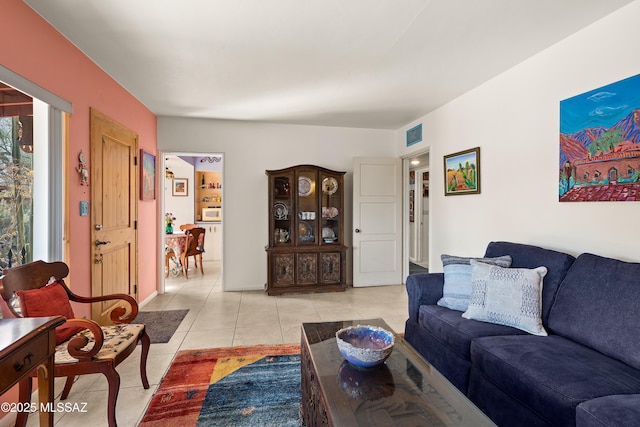 living area featuring visible vents and light tile patterned flooring