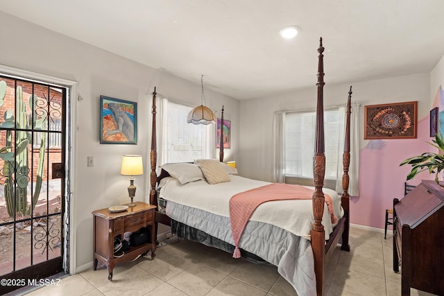 bedroom featuring light tile patterned floors, baseboards, and access to exterior