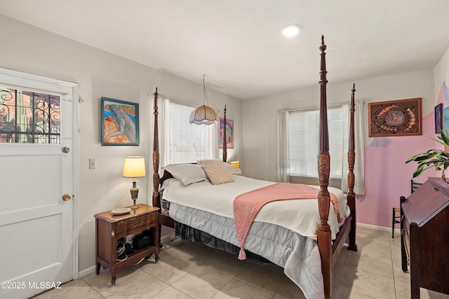 bedroom featuring light tile patterned flooring and baseboards