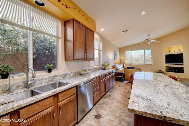 kitchen featuring visible vents, open floor plan, vaulted ceiling, a sink, and dishwasher