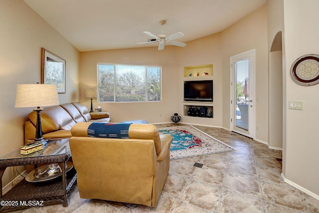 living area featuring baseboards, built in features, arched walkways, lofted ceiling, and ceiling fan