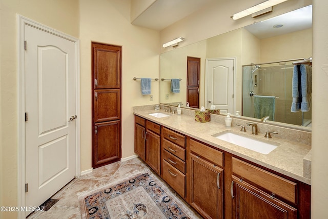 bathroom with double vanity, a stall shower, and a sink