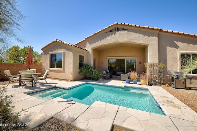 back of property with a patio area, fence, and stucco siding