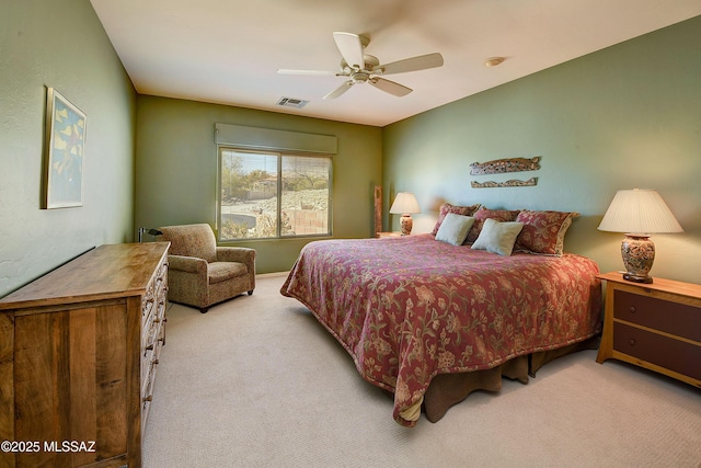 carpeted bedroom with visible vents and a ceiling fan